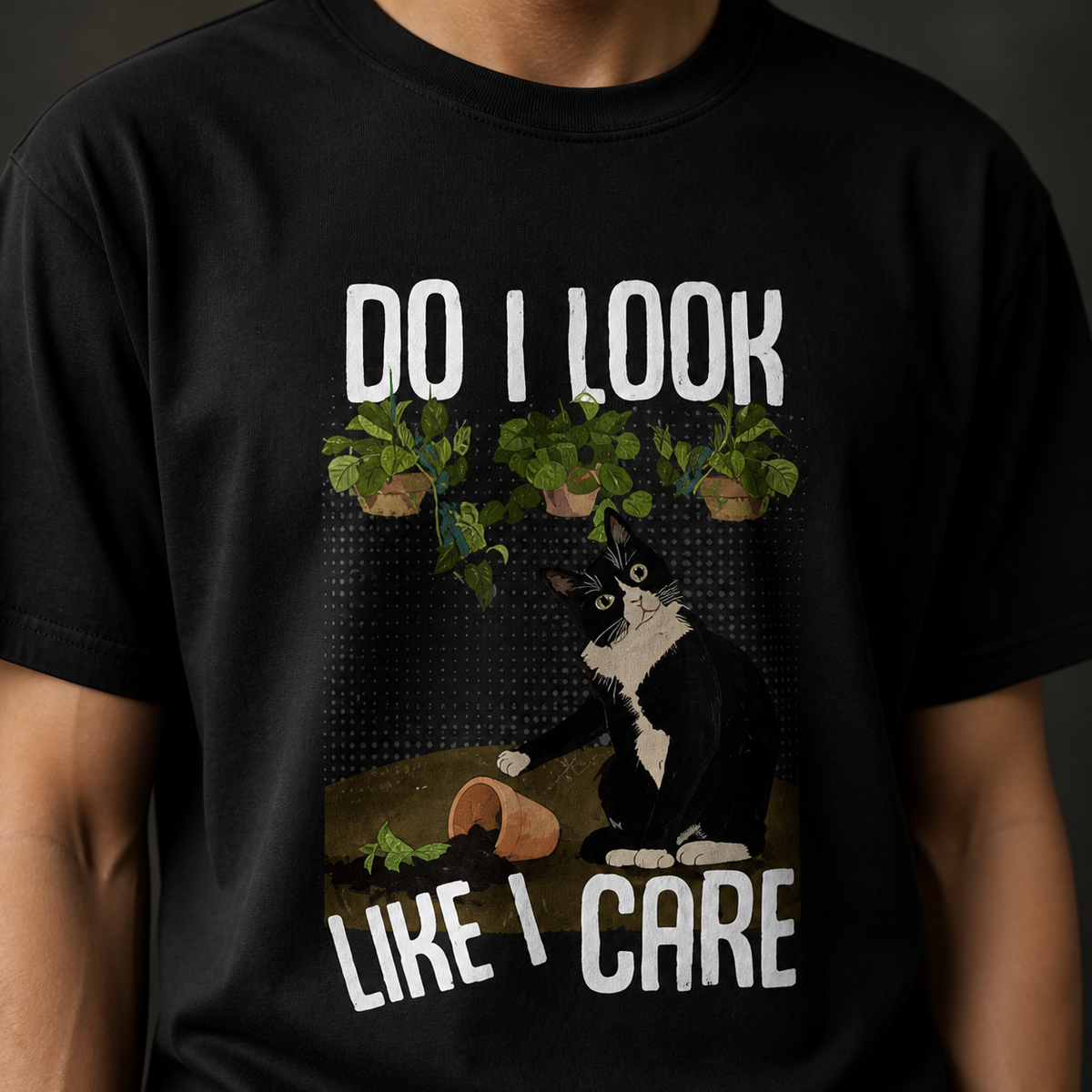 Close-up of black cotton T-shirt with cat and houseplant graphic print