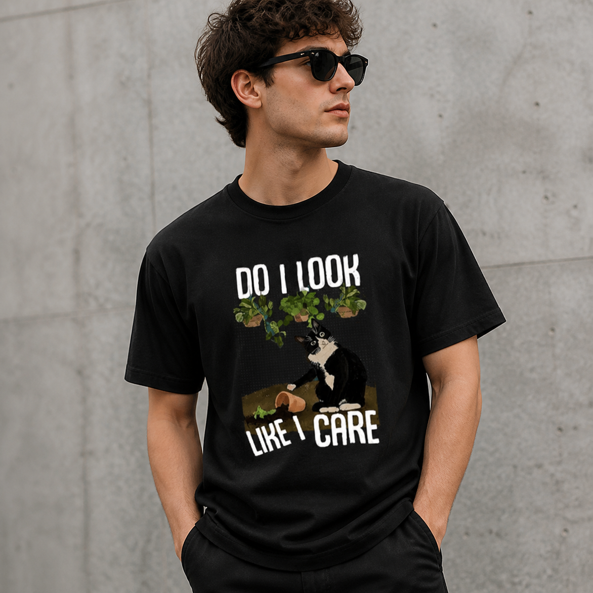 Adult model wearing black WEAVVI cat graphic T-shirt in an urban setting